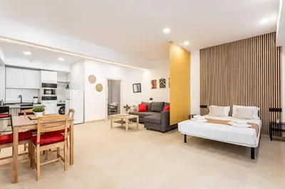 a large living room with a couch and a table at Torrefiel Charm Apartment in Valencia