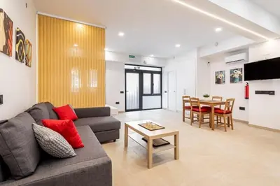 a living room with a couch and a table at Torrefiel Charm Apartment in Valencia