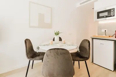 a dining room table with chairs in a kitchen at Apartamento en Valencia in Valencia