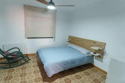 a wooden book shelf in a room with a bed at Las Salericas in Chella