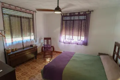 a room with two beds and a suitcase in it at Las Salericas in Chella