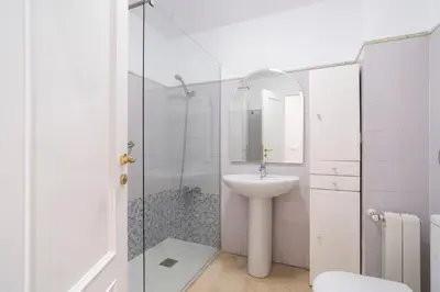 a white bathroom with a sink and a shower at VLC HOST - Linterna in Valencia