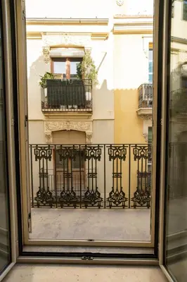 a window view of a building with a balcony at VLC HOST - Linterna in Valencia