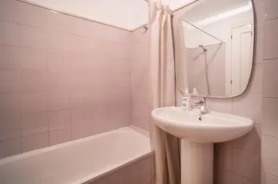 a white bathroom with a sink and a bath tub at VLC HOST - Linterna in Valencia