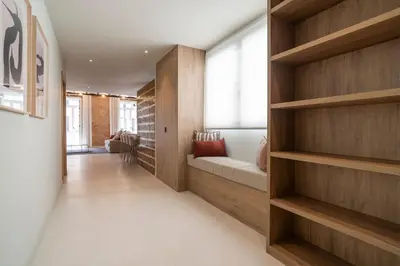 a hallway with wooden shelves and a couch in a room at VLC Host - Martí Apartments in Valencia