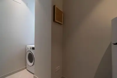 a washer and dryer in a bathroom with a wall at VLC Host - Martí Apartments in Valencia