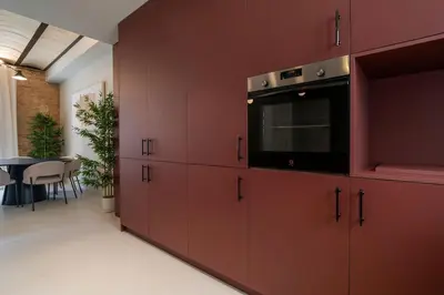 a kitchen with red cabinets with a microwave at VLC Host - Martí Apartments in Valencia