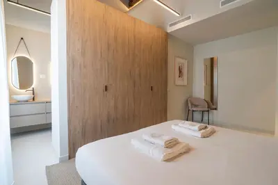 a bedroom with a bed with two towels on it at VLC Host - Martí Apartments in Valencia