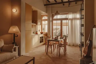 a kitchen and living room with a table and chairs at Casa Lina in Valencia
