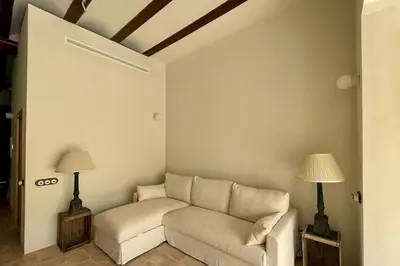 a living room with a couch and two lamps at Casa Lina in Valencia