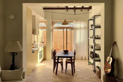 a kitchen and dining room with a table and a guitar at Casa Lina in Valencia