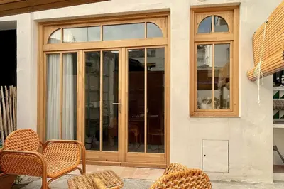 a patio with two chairs and a sliding glass door at Casa Lina in Valencia