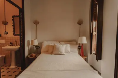 a bedroom with a bed with a sink and a mirror at Casa Rosalia in Valencia