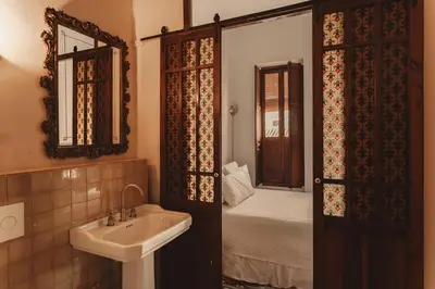 a bathroom with a sink and a bathroom with a bed at Casa Rosalia in Valencia