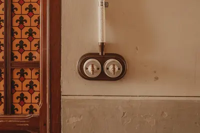 a wall with two thermostats on a wall at Casa Rosalia in Valencia