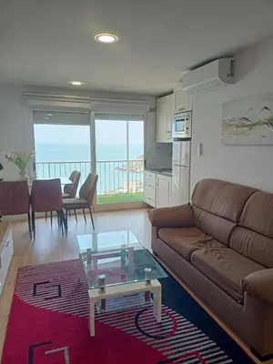 a living room with a couch and a table at APARTAMENTO Claudia FARO in Faro de Cullera