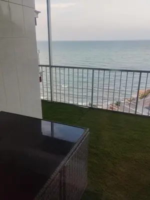 a view of the beach from the balcony of a building at APARTAMENTO Claudia FARO in Faro de Cullera