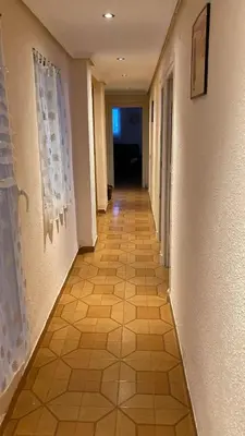 a hallway with a tiled floor in a building at Apartamento en Cullera playa con amplio balcón in Cullera