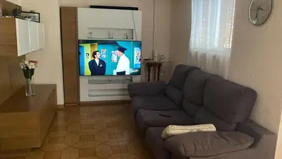 a living room with a couch and a flat screen tv at Apartamento en Cullera playa con amplio balcón in Cullera