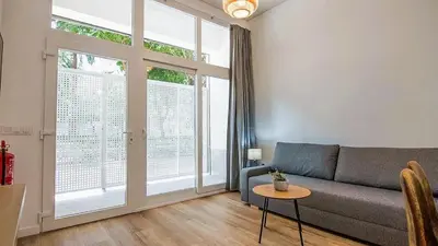 a living room with a couch and a large window at LUXURY APARTMENT SCIENCES CITY Valencia B in Valencia