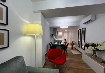 a living room with a red chair and a table at Las Arenas 1 Apartamento Playa in Valencia