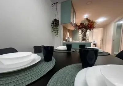 a dining table with white plates on top of it at Las Arenas 1 Apartamento Playa in Valencia