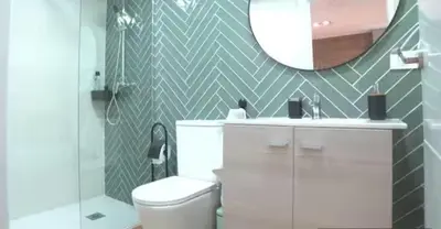 a bathroom with a white toilet and a mirror at Las Arenas 1 Apartamento Playa in Valencia