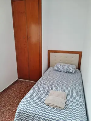 a bedroom with a bed with a pillow on it at APARTAMENTO COMODO FERIA dE VALENCIA in Valencia