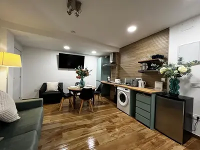 a kitchen and living room with a couch and a table at Playa Las Arenas 2 Apartamento in Valencia