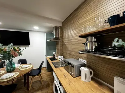 a kitchen with a counter and a table with a sink at Playa Las Arenas 2 Apartamento in Valencia