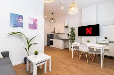 a white living room with a n on the wall at Nuevo acogedor cerca del Centro in Valencia