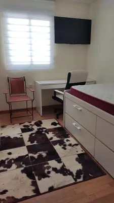 a bedroom with a bed and a desk and a rug at fully-equipped luxury penthouse in Almácera