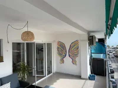 a room with a wall with a painting of fish at Seaview escape - spacious 3 bed beach apartment & terrace in Puerto de Sagunto