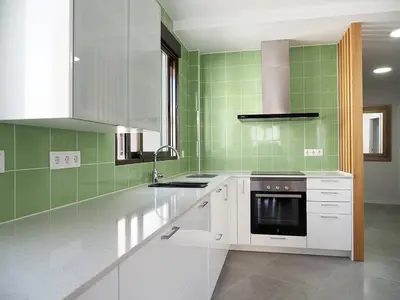 a kitchen with white appliances and green tiles at Apartamentos SAN JOSÉ in El Puig