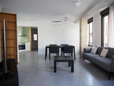 a living room with a couch and a table at Apartamentos SAN JOSÉ in El Puig
