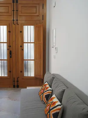 a living room with a gray couch with two pillows at Apartamentos SAN JOSÉ in El Puig