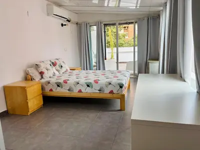 a small bedroom with a bed and a balcony at Reina loft in Valencia