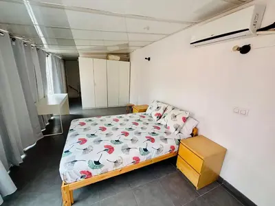 a small bedroom with a bed with a comforter at Reina loft in Valencia
