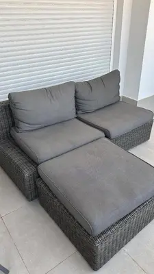 a grey couch sitting in a living room at Gran Canet, sea view 2beds in Canet de Berenguer