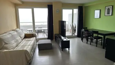 a living room with a couch and a table at Gran Canet, sea view 2beds in Canet de Berenguer