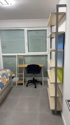 a bedroom with a desk and a bed and a shelf at Gran Canet, sea view 2beds in Canet de Berenguer