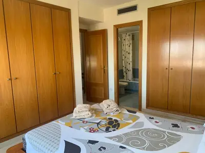 a bedroom with a bed with two towels on it at Atico Ciudad de las Ciencias Terraza y parking in Valencia