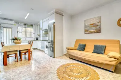 a living room with a couch and a table at Casa Playa Arenas con Terraza in Valencia