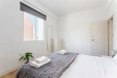 a white bedroom with two towels on a bed at GuestReady - Comfort in Valencia in Valencia