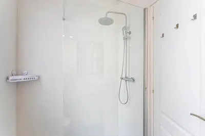 a shower with a glass door in a bathroom at GuestReady - Comfort in Valencia in Valencia