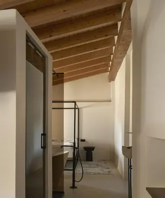 a room with a wooden ceiling and a glass door at Enoa Casa Cueva in Requena