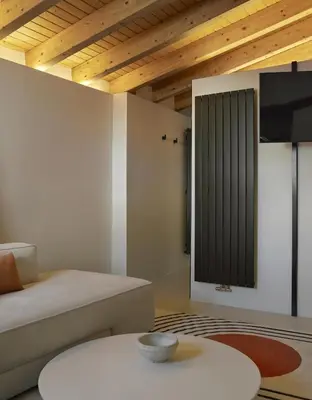 a living room with a bed and a table at Enoa Casa Cueva in Requena