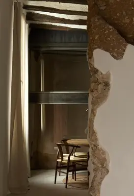 a table and chairs in a room with a window at Enoa Casa Cueva in Requena