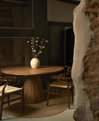 a table and chairs with a vase of flowers on it at Enoa Casa Cueva in Requena