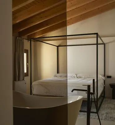 a bedroom with a bed and a bath tub at Enoa Casa Cueva in Requena